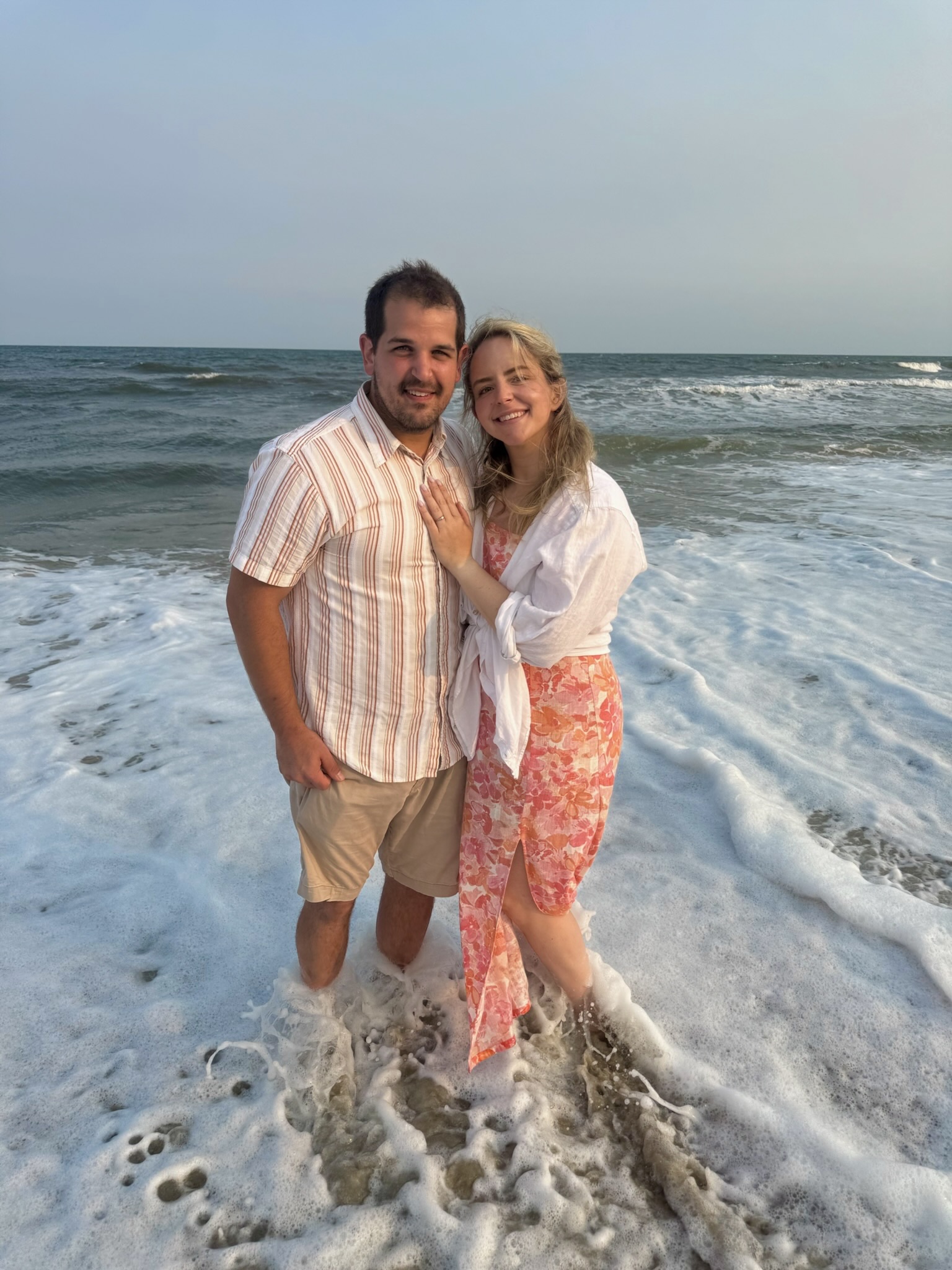 Peter and Mary embracing in the surf at the beach